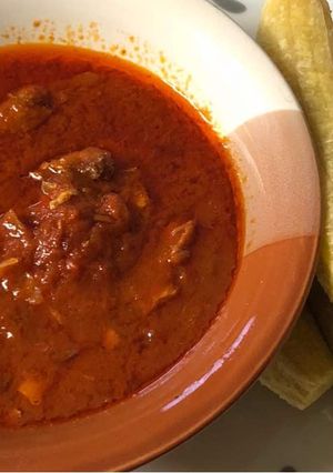 A picture of Tomatoes stew with boiled plantaini.