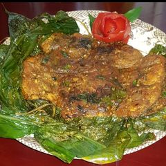 A picture of Fish fry with turmeric leaves.