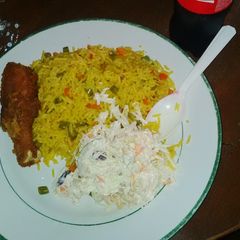 A picture of Fried rice, Cole slaw, fried chicken drum stick.