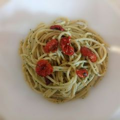 A picture of Spaghetti with walnut pesto and roasted tomatoes.