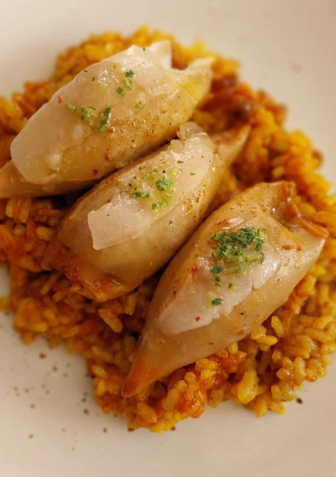 Una foto de Arroz con calamares rellenos de gambas y boloñesa con velo de panceta ibérica