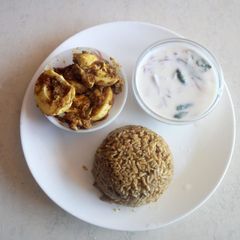 A picture of Tomato biriyani with egg gravy and curd bachadi.