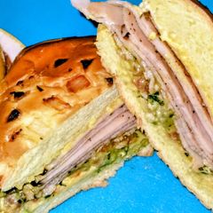 A picture of Turkey Sandwich on Onion Roll.