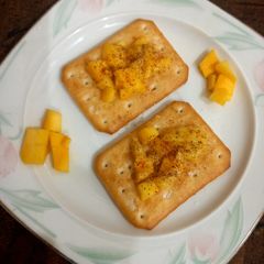 A picture of Tuc with mango chunks 🥭.