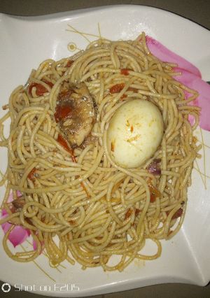 A picture of Spaghetti jollof with sardine and egg.