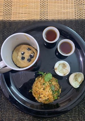 A picture of Chinese poha with bluberry mug pancake boiled egg and black coffee with tips for boiling eggs.
