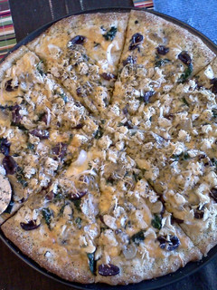 A picture of Tarragon chicken spinach alfredo pizza.
