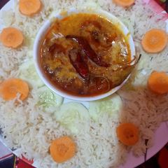 A picture of Restaurant style tadka daal with rice.