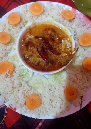A picture of Restaurant style tadka daal with rice.
