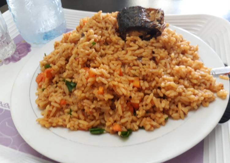 Tasty And Delicious of Jollof rice with carrots and green peas with fish