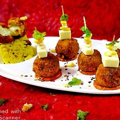 A picture of Puliyogare cheese burst bombs in pizza sauce.