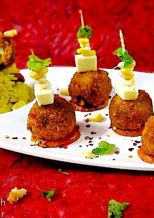 A picture of Puliyogare cheese burst bombs in pizza sauce.