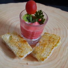 A picture of Tomato beetroot soup shooter with cheese bread.