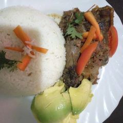 A picture of Kienyeji chicken stew with stir fried rice.