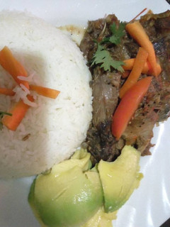 A picture of Kienyeji chicken stew with stir fried rice.