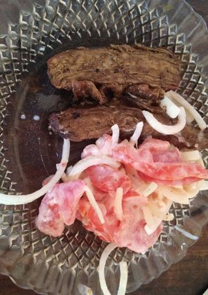 Una foto de Vacío con salsa de ajo y soja, ensalada de tomate y cebolla