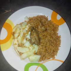 A picture of Jollof rice and cucumber.