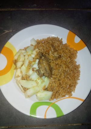 A picture of Jollof rice and cucumber.