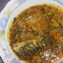 A picture of Egusi soup with cow head.