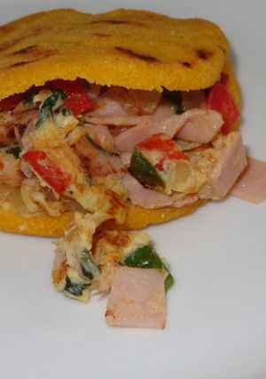 A picture of Arepas with Scrambled Eggs and Ham.