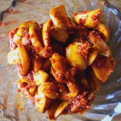 A picture of Wet yellow khajur pickle.