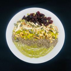 A picture of Avocado berries spinach smoothie bowl.
