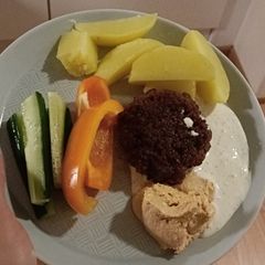 A picture of Beef burgers with side and garlic dip.