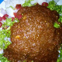 A picture of Rice and stew with salad.