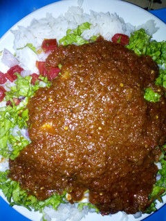 A picture of Rice and stew with salad.