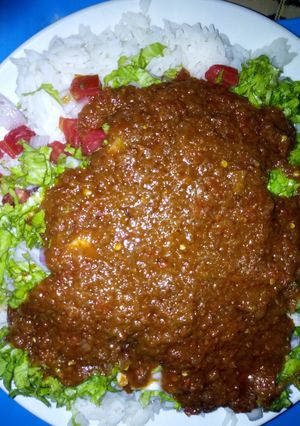 A picture of Rice and stew with salad.