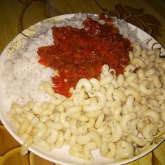 A picture of Rice and macaroni with stew.