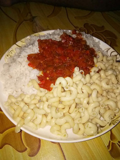 A picture of Rice and macaroni with stew.