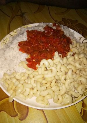 A picture of Rice and macaroni with stew.