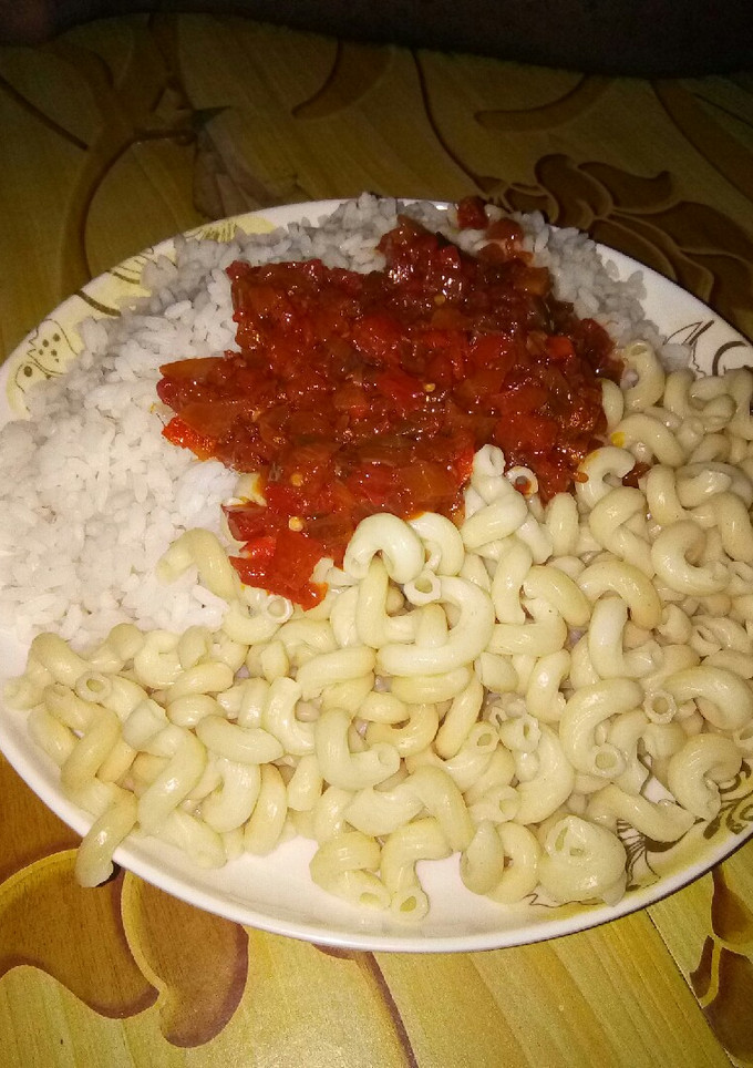 A picture of Rice and macaroni with stew.