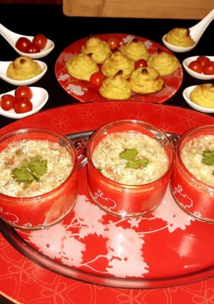 A picture of Tomato egg soup  with  buttery patatos  swirls.