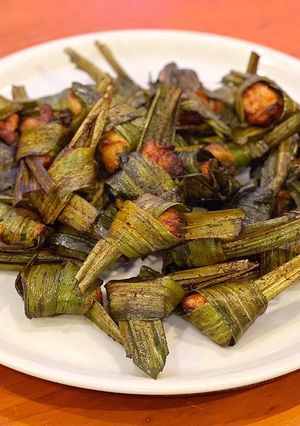 A picture of Chicken wrapped in fragrant pandanus leaves. (Pandan Chicken).