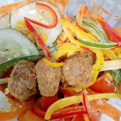 A picture of Fried Meat Balls on a stick and verggies.
