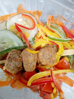 A picture of Fried Meat Balls on a stick and verggies.