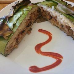 A picture of Sticky Rice Chicken Dumplings Wrapped in Banana Leaf.