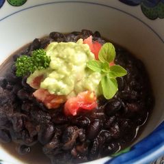 A picture of Black Bean Soup with Creamy Avocado.