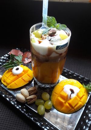 A picture of Mango-Coffee Smoothie with Ice-cream & chocolate syrup.
