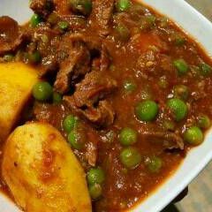 A picture of Beef stew with peas.