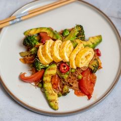 A picture of Stir fried noodle with cheesy Tamagoyaki and grilled soysauce avocado.