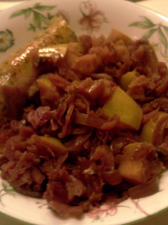 A picture of red cabbage with apples & wine.