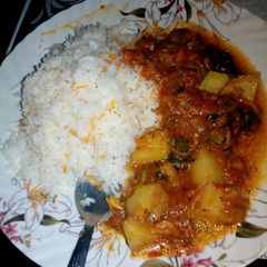 A picture of Tomato,potato spicy curry with rice.