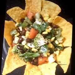 A picture of Mexican beans salad with nachos.