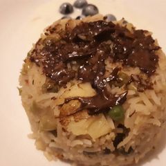 A picture of Fried rice with drizzled chocolate.