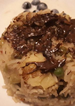 A picture of Fried rice with drizzled chocolate.