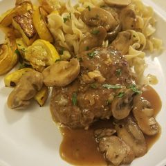 A picture of Salisbury Steak with mushroom gravy.