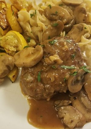 A picture of Salisbury Steak with mushroom gravy.